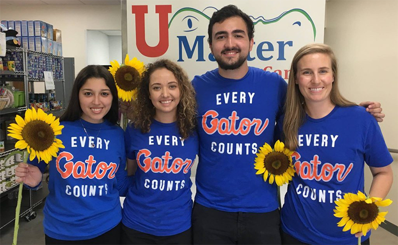 Field and Fork Partners holding Sunflowers